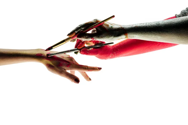 Painting hands together, friendship concept. Close up of hands holding paintbrushes, showing peoples diversity and tolerance to each other. Hard living in multicultural world. — Stock Photo, Image