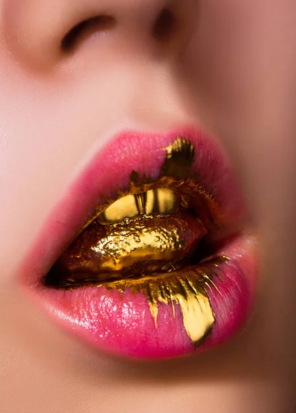 Golden tongue. Oral caress. Woman concept. Expensive cosmetics. Beauty and fashion. Style icon. Rich addiction. Female face with gold gloss in open mouth. Lips and Teeth in Golden Moisture. Sexy kiss. — Stock Photo, Image