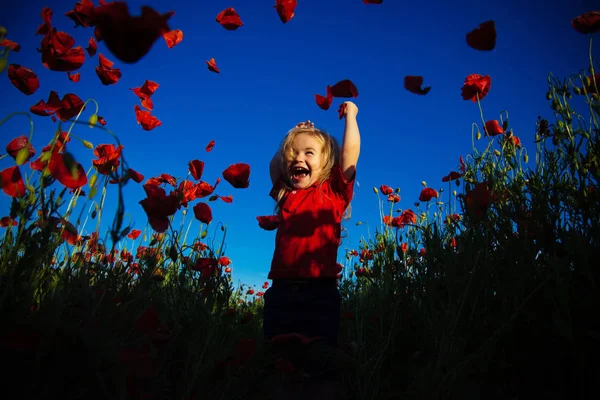 Happy summer. Red poppy flowers. Smile child boy jumping in nature against blue sky. Happy holidays. — Stock Photo, Image