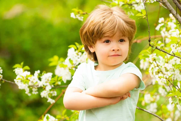 Zomer Kid model. Knappe jonge jongen op natuur bloesem achtergrond. Een zelfverzekerde trotse jongen. Kleine tuinman. Kind in de tuin. Zeg nee tegen allergieën. Schattig kind. — Stockfoto