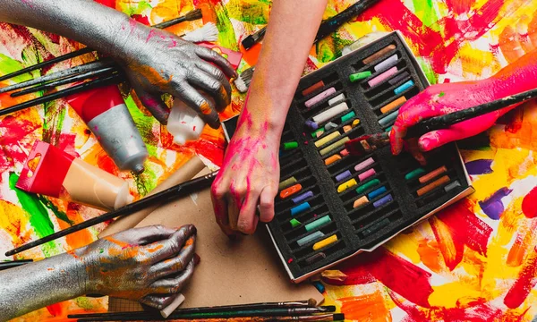 Living in multicultural world cause different problems. Close up of humans hands of different nations. Unity in diversity, celebration of national difference. Colorful photo of hands painting