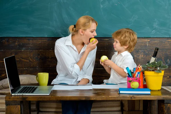 Meals at school. Snack. Healthy food for children. Mom and son eat an apple. Teacher and student eat food. Smart healthy family. Fruit for snacking at school.