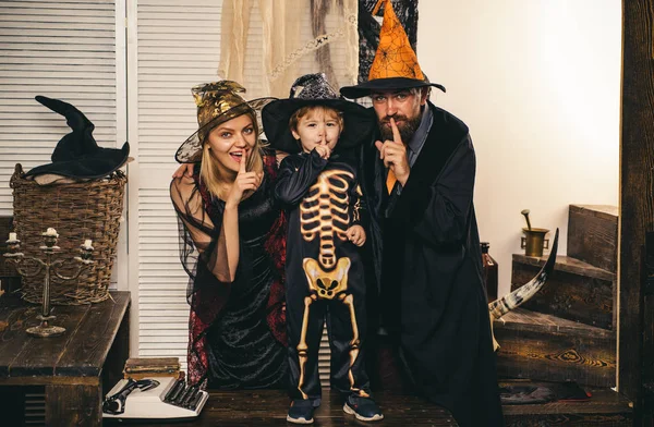 Skeleton posing with parents. Happy childhood. Family traditions for Halloween. Witch hat. Happy Halloween for Spooky Fun. Halloween dresses and witch costumes and witch hats. — Stock Photo, Image
