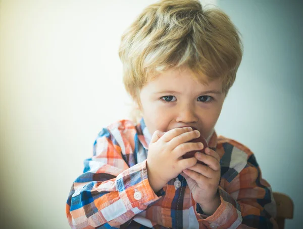 Mellanmål. Pojke äter äpple. Barn äter frukt. Röd äpple bitande. Little Kid Boy porträtt, äta rött äpple. Hälsosam mat mellanmål för barn. — Stockfoto