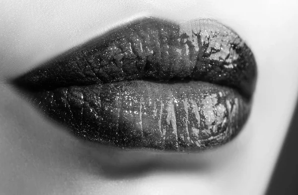 Lips. Lipstick. Lip gloss. Female mouth close up. Full lips. Sensual kiss. Cosmetics concept. Lip balm.