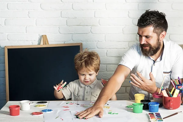 Stationery. Hand drawing. Creative therapy. Father and son draw together. Childhood. A happy family. Stationery shop.