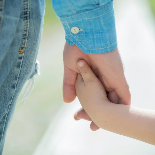 Hände. Vater und Sohn. Eltern und Kinder. Liebe und Fürsorge. Vormundschaft. Pflegeeltern. Adoptivkinder. Spaziergang mit Papa. Tochter oder Sohn halten Väter an der Hand. Stieftochter. — Stockfoto