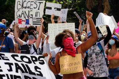 Miami Downtown, FL, USA - MAY 31, 2020: I am Breonna Taylor, woman on peaceful protests in the US against the George Floyd death: people are protesting. Female activist protestor. clipart