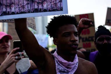 Miami Downtown, FL, ABD - 31 Mayıs 2020: Amerika Birleşik Devletleri 'nde ırkçılığa karşı bir gösteri sırasında domuzların fotoğrafıyla siyahi adam. Minneapolis 'li zalim polise karşı halk.