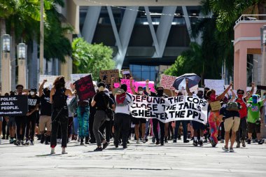 Miami Downtown, FL, USA - MAY 31, 2020: Justice for George Floyd. Demonstration against racism, US activist. Emotional anti racism demonstrations. Protests in the United States. clipart