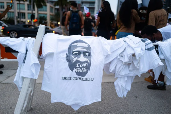 Miami Downtown, FL, USA - Június 7, 2020: Üzleti tüntetések a rasszizmus ellen. Az ember pólókat árul George Floyd portréjával.. — Stock Fotó