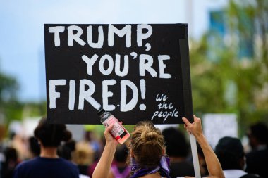 Orlando, FL, USA - JUNE 19, 2020: Trump, you are fired poster. Demonstration in the USA. Voters and politics. US President Donald Trump impeachment. Elections, election campaign. Vote 2020 clipart