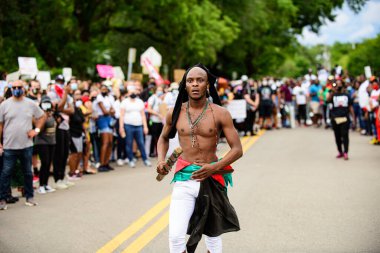 Orlando, FL, USA - JUNE 19, 2020: U.S. Black Rights Fighter. Black man at a demonstration. clipart