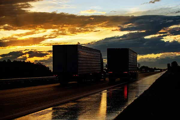 Trucks on a sunset background. Beautiful truck on the roads of America. Business and transport.