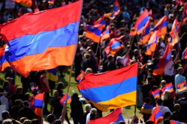 Many Armenian flags at a mass demonstration against the bombing of Artsakh. Demonstration against Armenia - Azerbaijan conflict for Artsakh. clipart