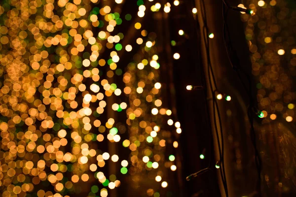 Bokeh of Christmas lights on a large window in a restaurant. Twinkle close up and bokeh.