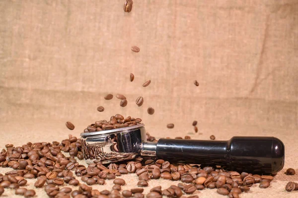 A lot of coffee beans. Beautiful background. Coffee beans sprinkling.