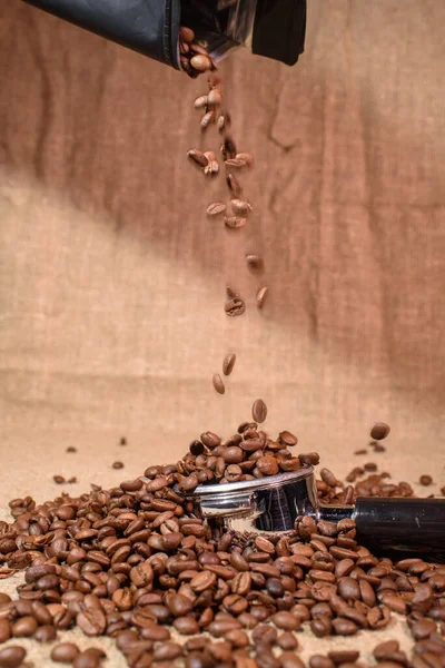 A lot of coffee beans. Beautiful background. Coffee beans sprinkling.