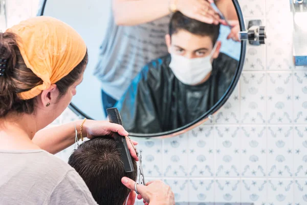 Mother Cutting Her Son Hair Protective Mask Mirror Quarantine Covid — Stock Photo, Image