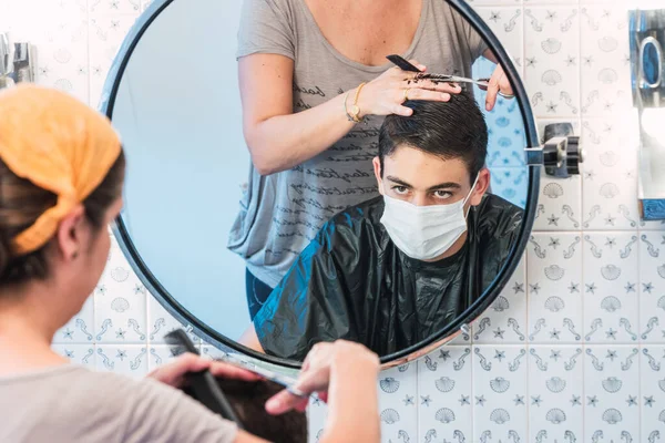 Son Wearing Face Mask While His Mother Cuts His Hair — Stock Photo, Image