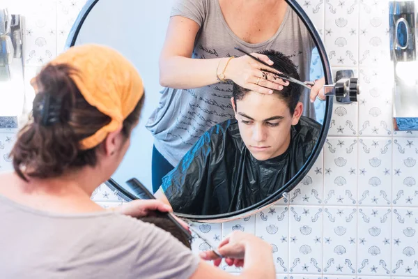 Mother Cutting Her Son Hair Scissors Comb Home Seen Mirror — Stock Photo, Image