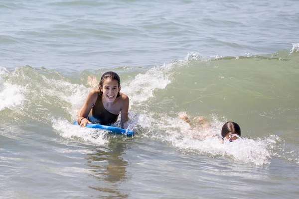 Two Happy Girls Surfing Having Fun Bodyboard Beach — Stock Photo, Image