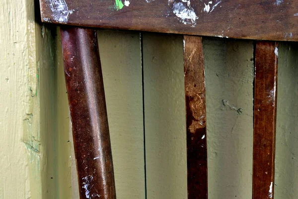 the upper part of the back of the chair is stained with paint