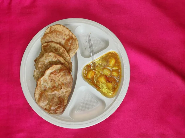 Puri a bramborové kari aalu sabji - indická kuchyně v kulatém talíři. — Stock fotografie