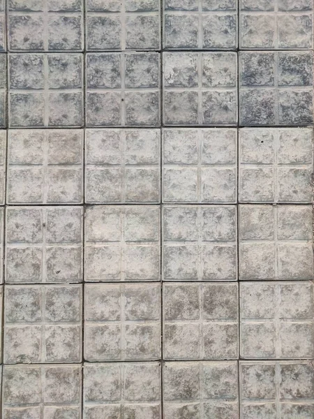 Quadratisches Pflaster strukturierte Fliesen grau und dunkle Farbe Steinmaterial — Stockfoto
