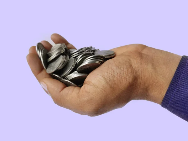 Silver coins in hand side view on blue background — Stock Photo, Image