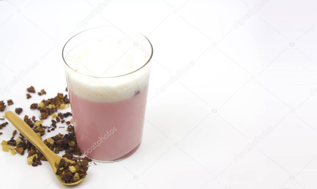 Pink Moon Milk for a better sleep, midnight relaxing drink. Immunity, beverage. A glass next to the spoon with species on white background. space for text