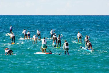 04 Oct 2020: Garraf, Spain. Stand up paddle surfing or SUP competition. the competition has begun. many boards in the water. people rowing with paddles clipart