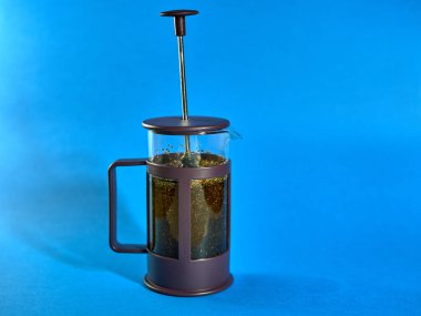 Mavi arka planda çay dolu sürahi.