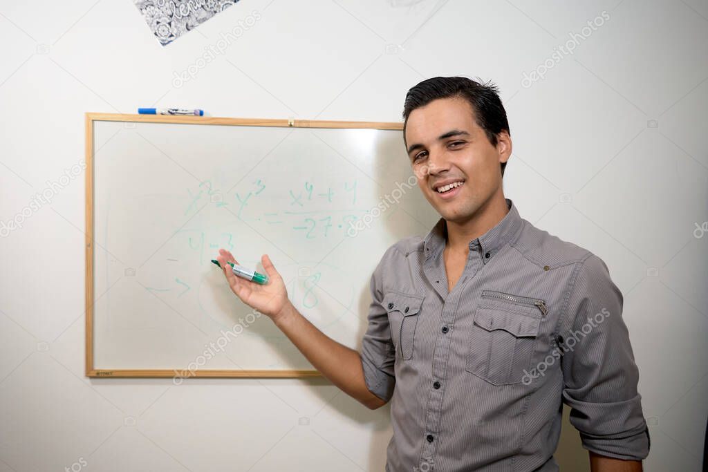 dark-haired boy showing white board