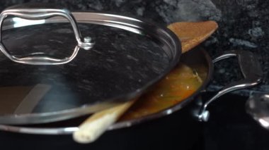 Tahta kaşıklı tencere paella yapıyor.