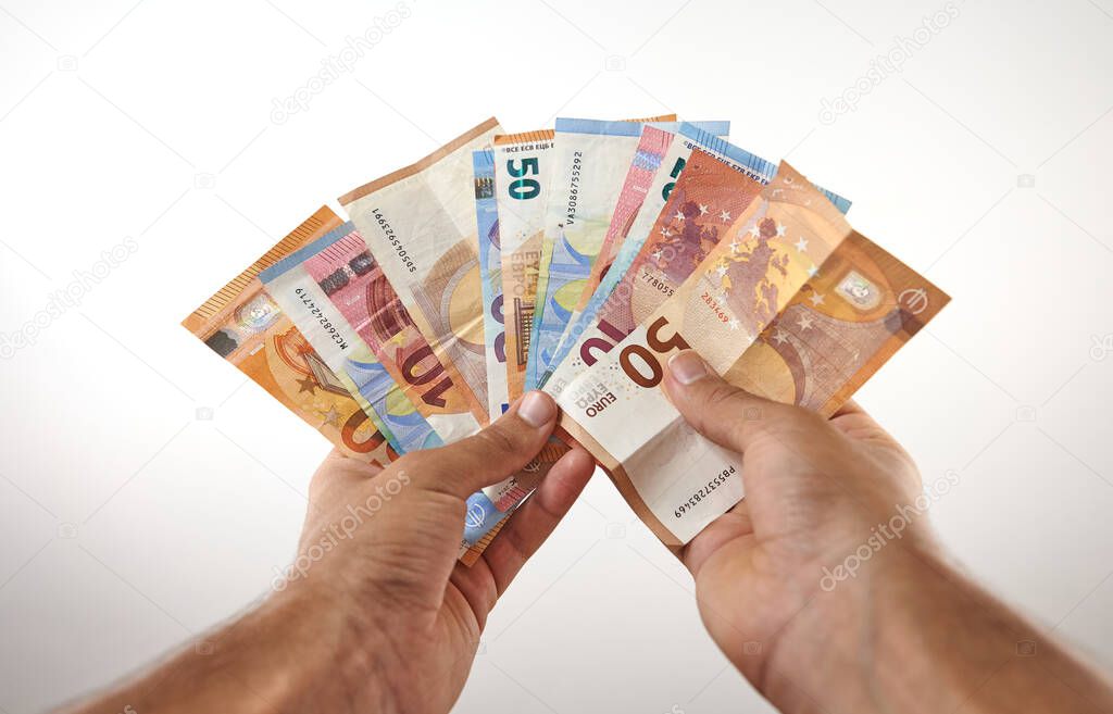 hands holding lot of money on white background