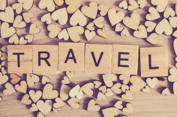 Travel concept . travel word on wooden cube block on wood background decoration