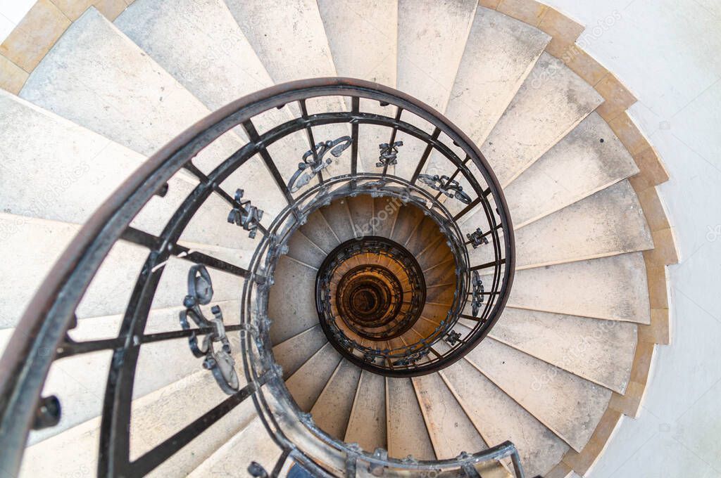 Spiral stone staircase with metal railings. St. Stephen's Basilica, Budapest