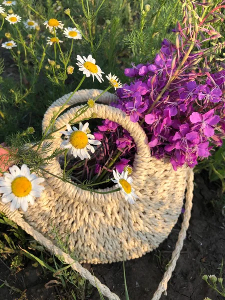 Wicker bag with flowers.