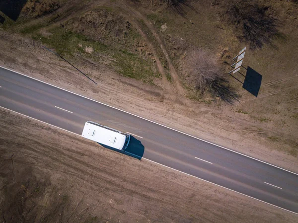 Aerial of a school bus on a rural highway. Aerial top down shot. — Stock Photo, Image