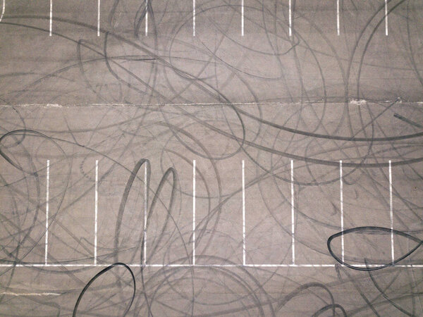 Aerial top down drone shot. Parking with tire tracks. Drifting location.