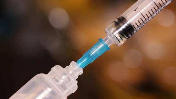 Close up macro shot of medical syringe with drug or vaccine on blured background. Healthcare and drug addiction concept. — Stock Video