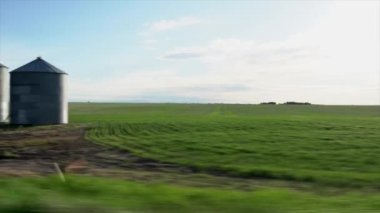 Yakın zamanda Alberta Kanada 'daki Kanada ovalarında tarım endüstrisini ön plana çıkaran büyük metal tahıl ambarları ekilen bir sürüş..