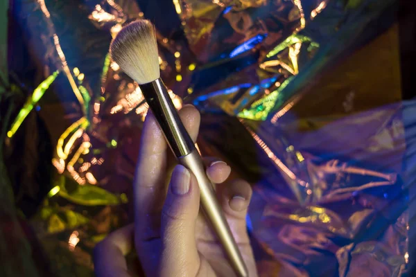 Girl Holds Golden Makeup Brush Shining Background — Stock Photo, Image