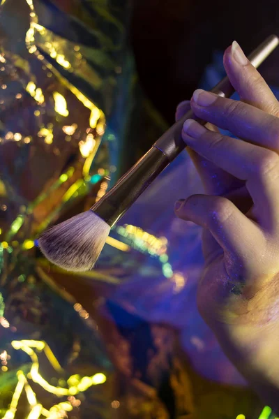 Girl Holds Golden Makeup Brush Shining Background — Stock Photo, Image