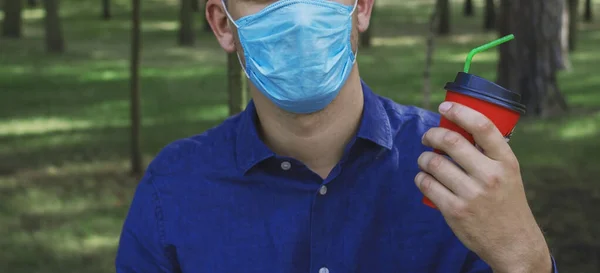 Guy Medical Mask Holds Coffee Orange Takeaway Cup His Hand — Stock Photo, Image