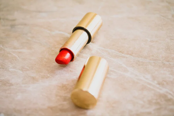 Red Lipstick Gold Tube Marble Table — Stock Photo, Image