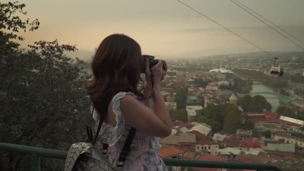 Woman tourist taking photo by camera of the old city — Stock Video