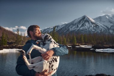 Köpeği ile açık havada dağ arazi oynayan adamım