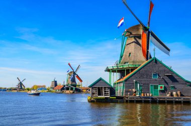 Geleneksel Hollanda yel değirmenleri ve Zaanse Schans, Hollanda, Avrupa 'daki kanal yakınlarındaki evler